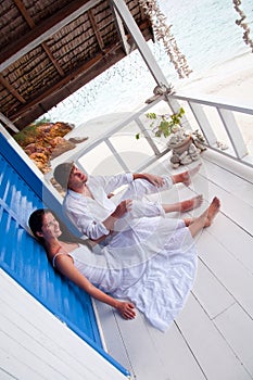 Romantic young couple in tropical beach house