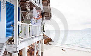 Romantic young couple in tropical beach house