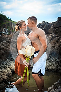 Romantic young couple in tropical beach rocky lagoon