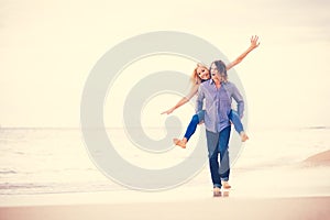 Romantic Young Couple Walking on the Beach