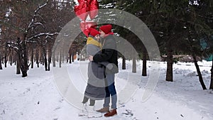 Romantic young hipster couple's love time in winter park. Love, valentines and holiday concept. Kiss and hug