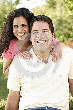 Romantic Young Hispanic Couple Relaxing In Park