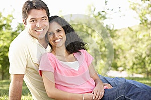 Romantic Young Hispanic Couple Relaxing In Park