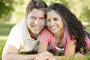 Romantic Young Hispanic Couple Relaxing In Park