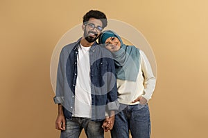 Romantic Young Muslim Couple Holding Hands And Looking At Camera