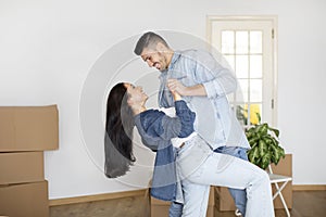 Romantic Young Spouses Dancing In Living Room Of Their New Flat