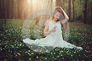 Romantic young woman in beautiful meadow