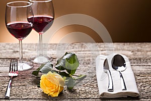 Romantically laid table with yellow roses and wine, romantic atmosphere