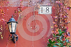 Rome architecture detail with street lamp and house number