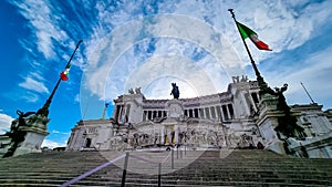 Rome - Italian national flag with scenic view on the front facade of Victor Emmanuel II monument on Piazza Venezia in Rome