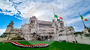 Rome - Italian national flag with scenic view on the front facade of Victor Emmanuel II monument on Piazza Venezia in Rome