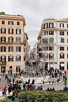 Rome, Italy 07 April, 2022 - The Fontana Della Barcaccia. Piazza di spagna in Rome. Tourists visiting the spanish square