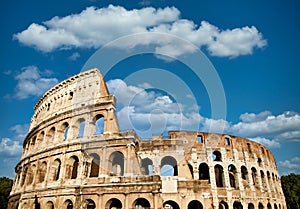 Rome, Italy. Arches archictecture of Colosseum exterior with blue sky background and clouds