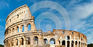 Rome, Italy. Arches archictecture of Colosseum exterior with blue sky background and clouds