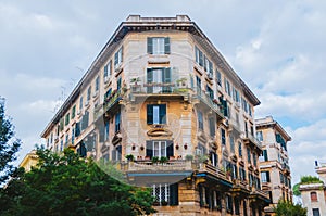 Rome, Italy - A beautifully architectured apartment in downtown Rome during a cloudy afternoon with the classical green windows