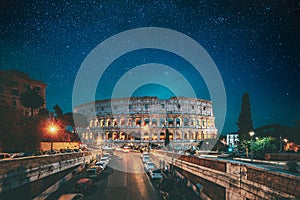 Rome, Italy. Bold Bright Blue Azure Night Starry Sky With Glowing Stars Above Colosseum Also Known As Flavian