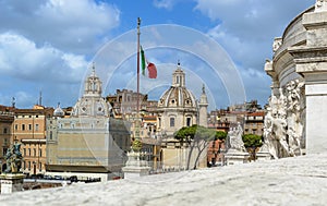 Rome, Italy. Churches, Trajan`s Column and Italian flag - view from Vittorio Emanuele monument
