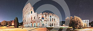 Rome, Italy. Colosseum Also Known As Flavian Amphitheatre In Evening Or Night Time. Bold Bright Blue Night Starry Sky