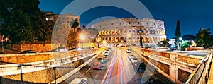 Rome, Italy. Colosseum Also Known As Flavian Amphitheatre. Traffic In Rome Near Famous World Landmark In Evening Time.