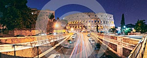 Rome, Italy. Colosseum Also Known As Flavian Amphitheatre. Traffic In Rome Near Famous World Landmark In Evening Time