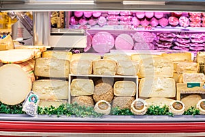 Cheese department. Variety of Italian cheeses. Showcase with different dairy products.
