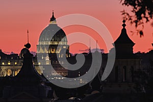 Rome, Italy, Dome of St Peter Basilica at sunset on a background of red sunset sky