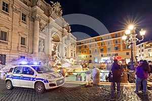 Police car at the Trevi Fountain in Rome at night, Italy