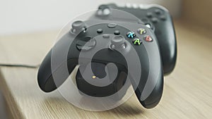 Rome, Italy - June, 05 2020, black PS4 controller in charge on the special dual charging dock.