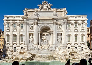 Tourists in front of the magnificent `Trevi Fountain. ` Some take pictures, others do selfies.