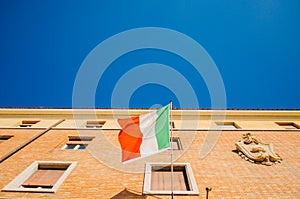 Rome, Italy - A minimalistic upper view of an italian flag moving to the left and attached to a pole in a residential apartment