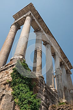 Rome, Italy - Temple of Saturn columns at the Roman Forum. Heart of Ancient Rome. Roman Empire political center ruins.