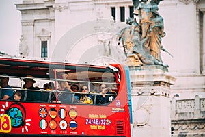 Rome, Italy. Tourists In Red Hop On Hop Off Touristic Bus For Sightseeing In Street Near Altar Of The Fatherland On