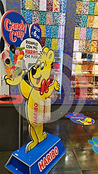 Golden teddy bear display wall of Haribo candies of various flavors for sale by weight in multiplex cinema. Bonn-based German