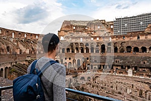 Rome - Man tourist with view on the interior of Colosseum of city of Rome, Lazio, Italy, Europe. UNESCO World Heritage Site