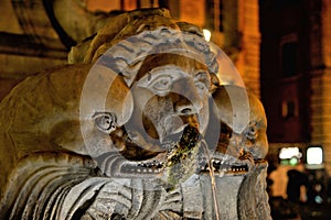 Rome night street with sculpture and old fontaine, italy