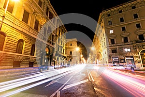 Rome road at night, urban traffic light trails and citylife. Italy