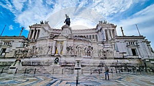 Rome - Tourist man standing in front of the massive facade of Victor Emmanuel II monument on Piazza Venezia in Rome