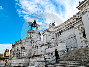 Rome - Tourist woman standing in front of the massive facade of Victor Emmanuel II monument on Piazza Venezia in Rome