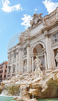 Rome trevi fountain and art statue Fontana di Trevi in Rome, Italy with bright day blue sky. Trevi is most famous fountain of