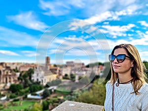 Rome - Woman with panoramic view on the Roman Forum and Rome Skyline from the Palatine Hill in the ancient city of Rome, Lazio