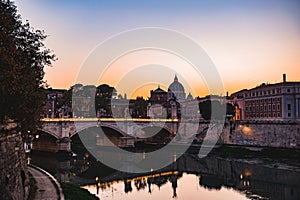 Rome's Ponte Sant'Angelo and St. Peter's Basilica at sunset. photo