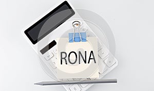 RONA text on the sticker on the white calculator photo