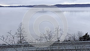 Rondaut lighthouse and train tracks, foggy dusk on Hudson river New York USA