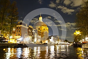 Ronde Lutherse Kerk next to Singel canal in Amsterdam at night