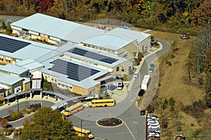 Roof of american school building covered with photovoltaic solar panels for production of electric energy. Renewable