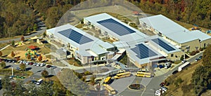 Roof of american school building covered with photovoltaic solar panels for production of electric energy. Renewable