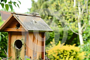 roof attachment on a wooden birdhouse outdoors