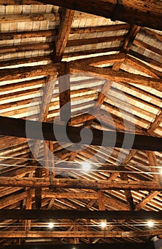 Roof with beams facing bricks and halogen lamps photo