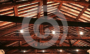 The roof with beams facing bricks and halogen lamps photo