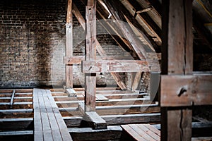 Roof beams in old, empty attic / loft before renovation / construction concept